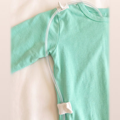 Line threaded through the shoulder and lower-back RoutePoints on a Calm Mint adaptive garment