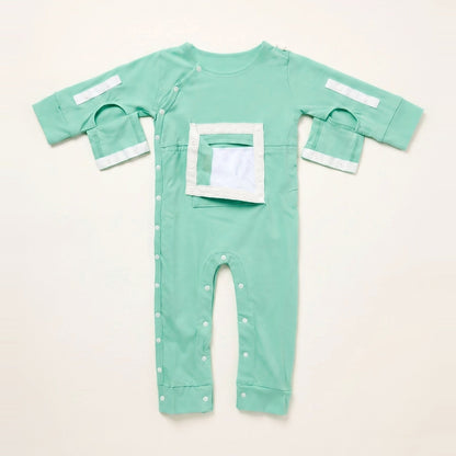 Calm Mint central line bodysuit with the PediaPouch chest pocket opened, showing the moisture-resistant interior lining