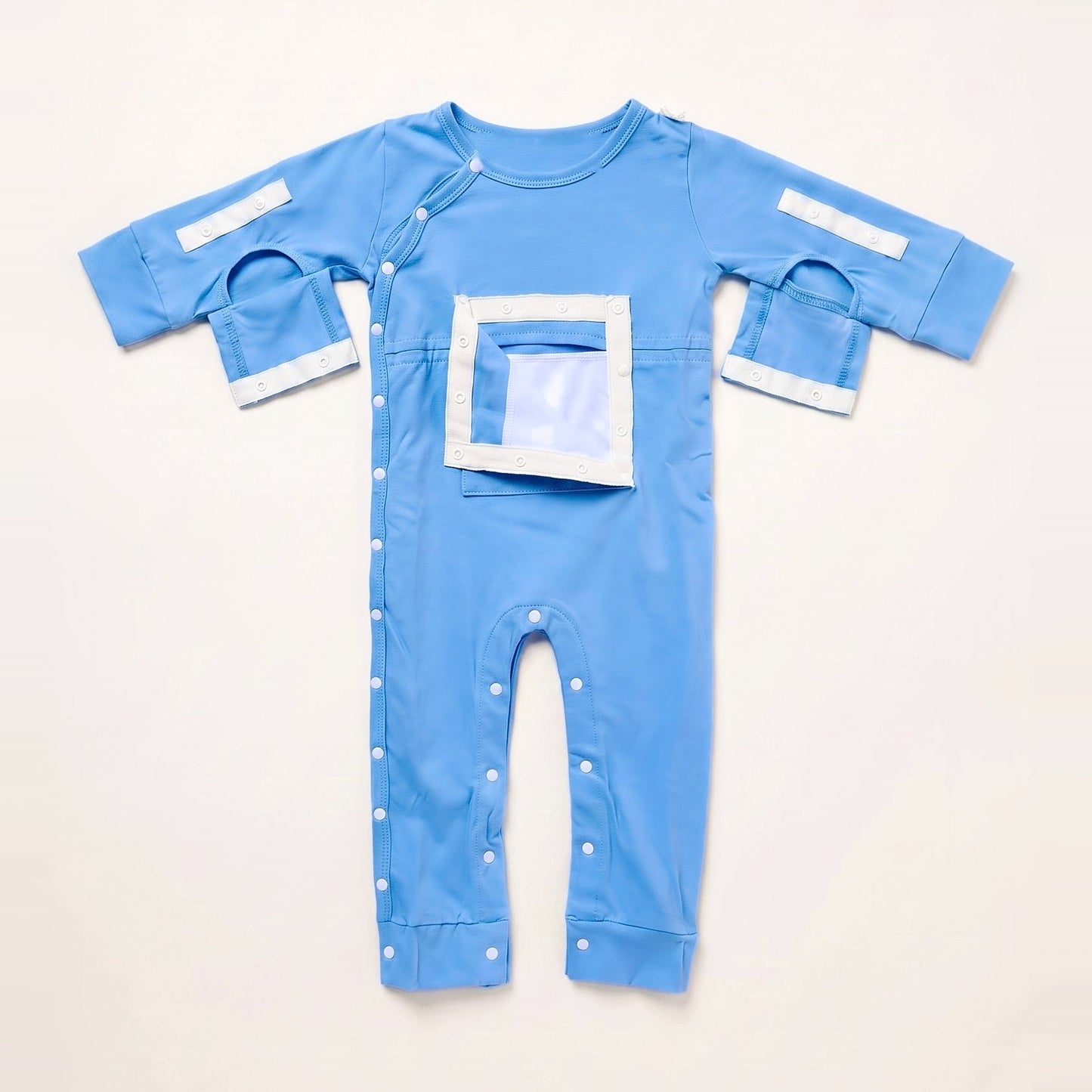Sky Lullaby central line bodysuit with the PediaPouch chest pocket opened, showing the moisture-resistant interior lining