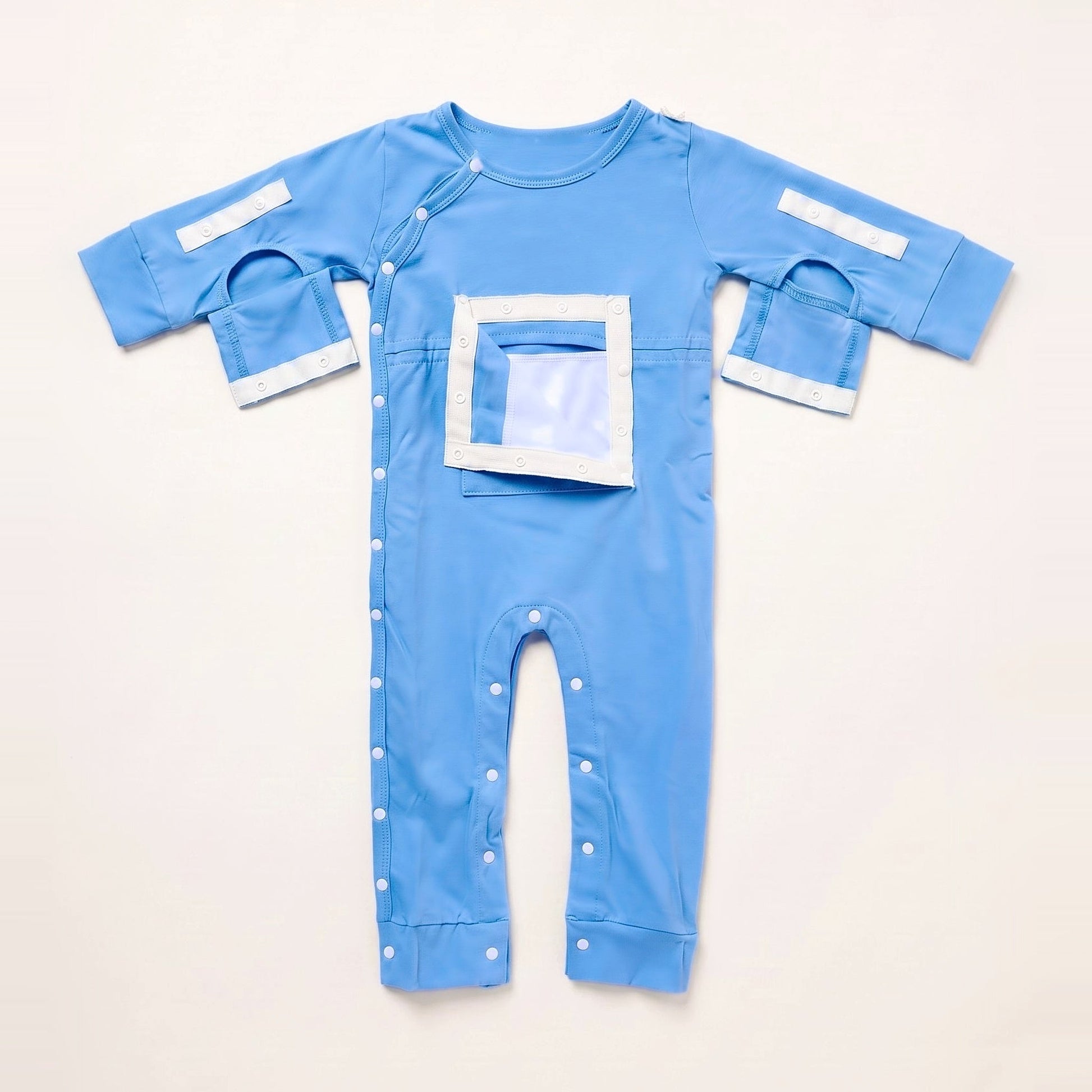 Sky Lullaby central line bodysuit with the PediaPouch chest pocket opened, showing the moisture-resistant interior lining