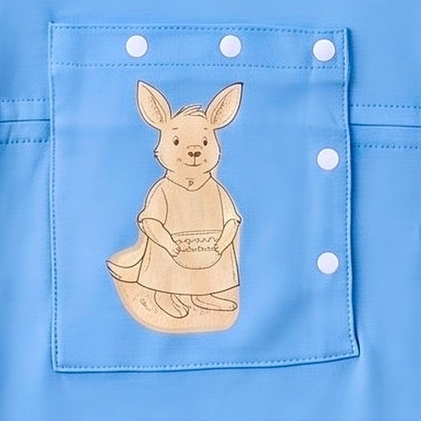 Close-up of the centred PediaPouch snap-close chest pocket with kangaroo detail on the Sky Lullaby bodysuit