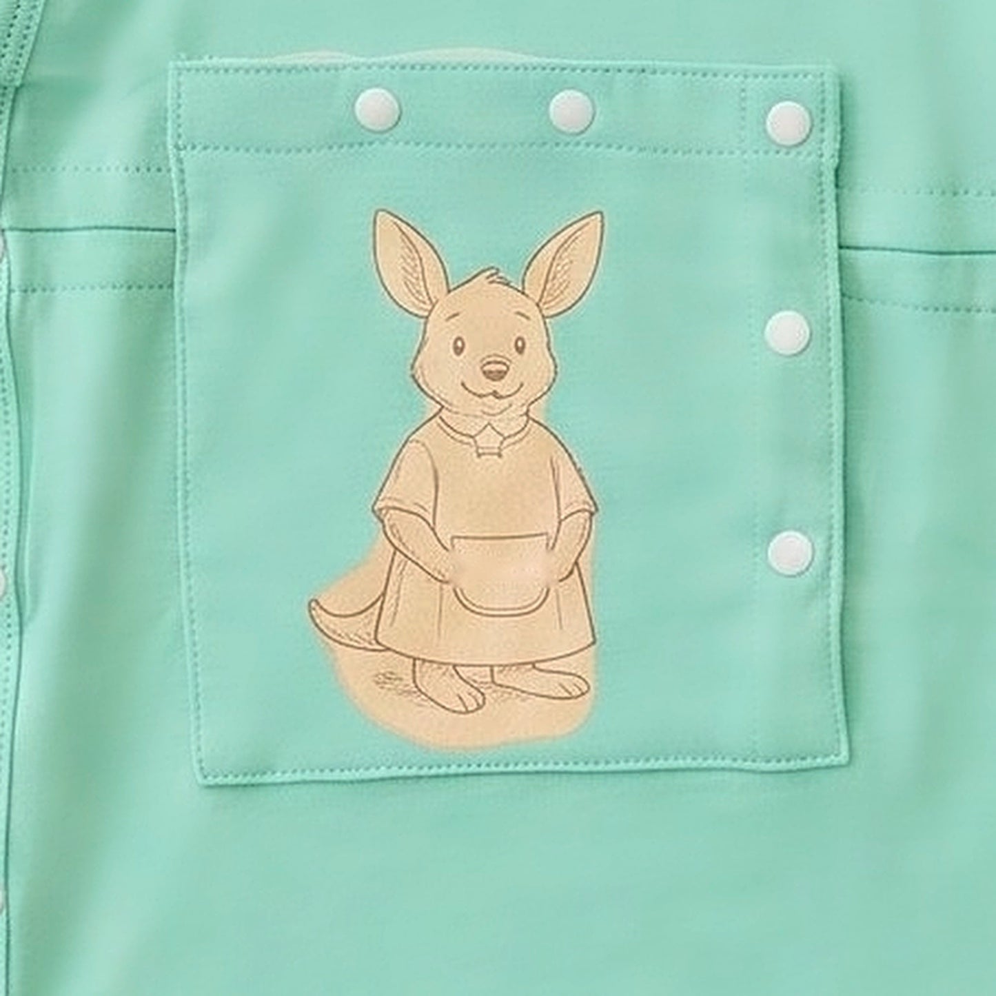 Close-up of the centred PediaPouch snap-close chest pocket with kangaroo detail on the LineWear infant gown