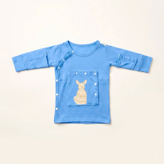 LineWear Chest Edition adaptive central line gown for newborns in Sky Lullaby blue, laid flat with the PediaPouch chest pocket closed