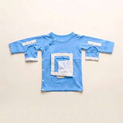 Sky Lullaby central line gown with the PediaPouch chest pocket opened, showing the moisture-resistant interior lining