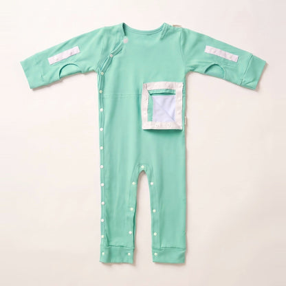 Calm Mint G/J tube bodysuit with the PediaPouch opened, showing the moisture-resistant interior lining