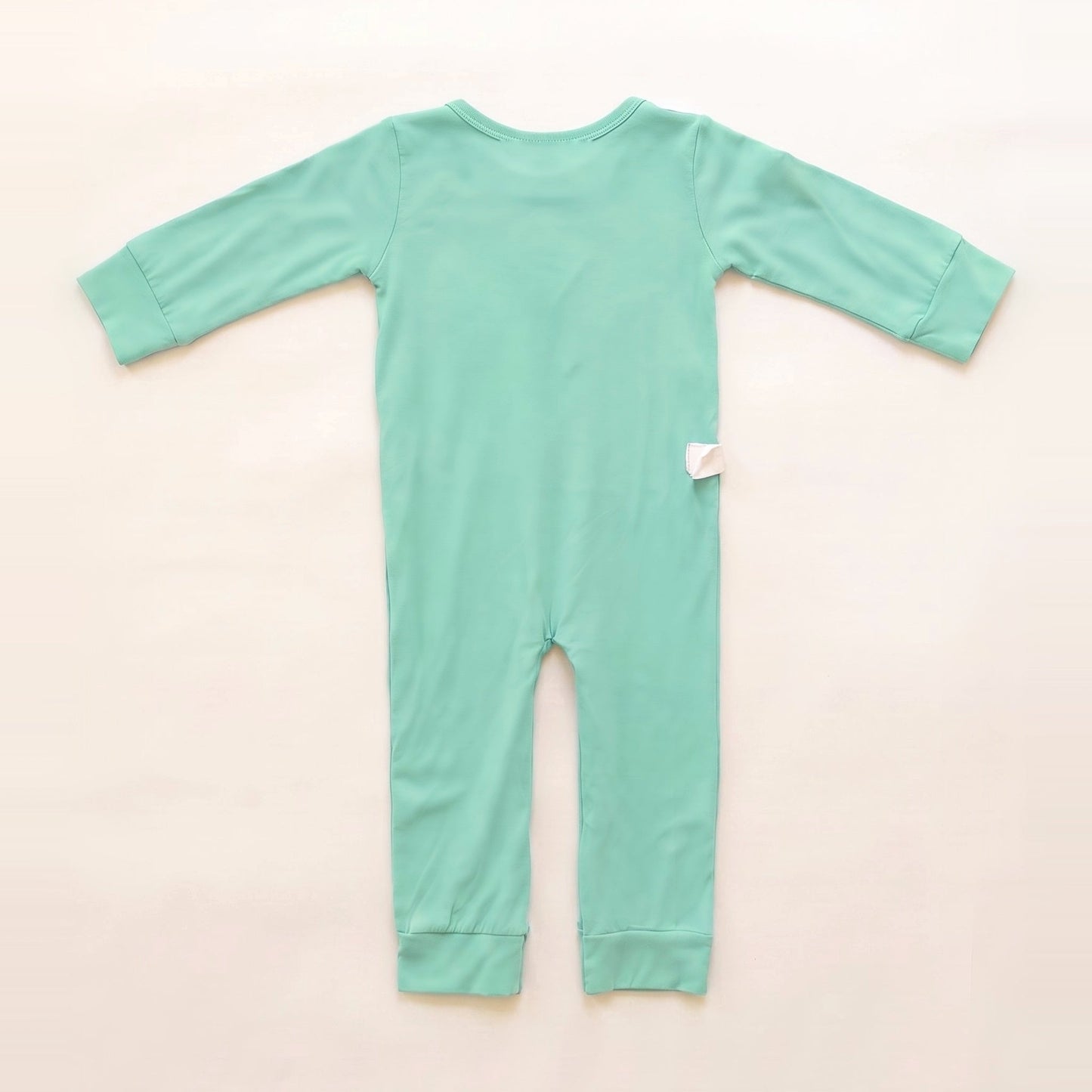 Back of the Calm Mint adaptive bodysuit showing shoulder and lower-back RoutePoints line guides