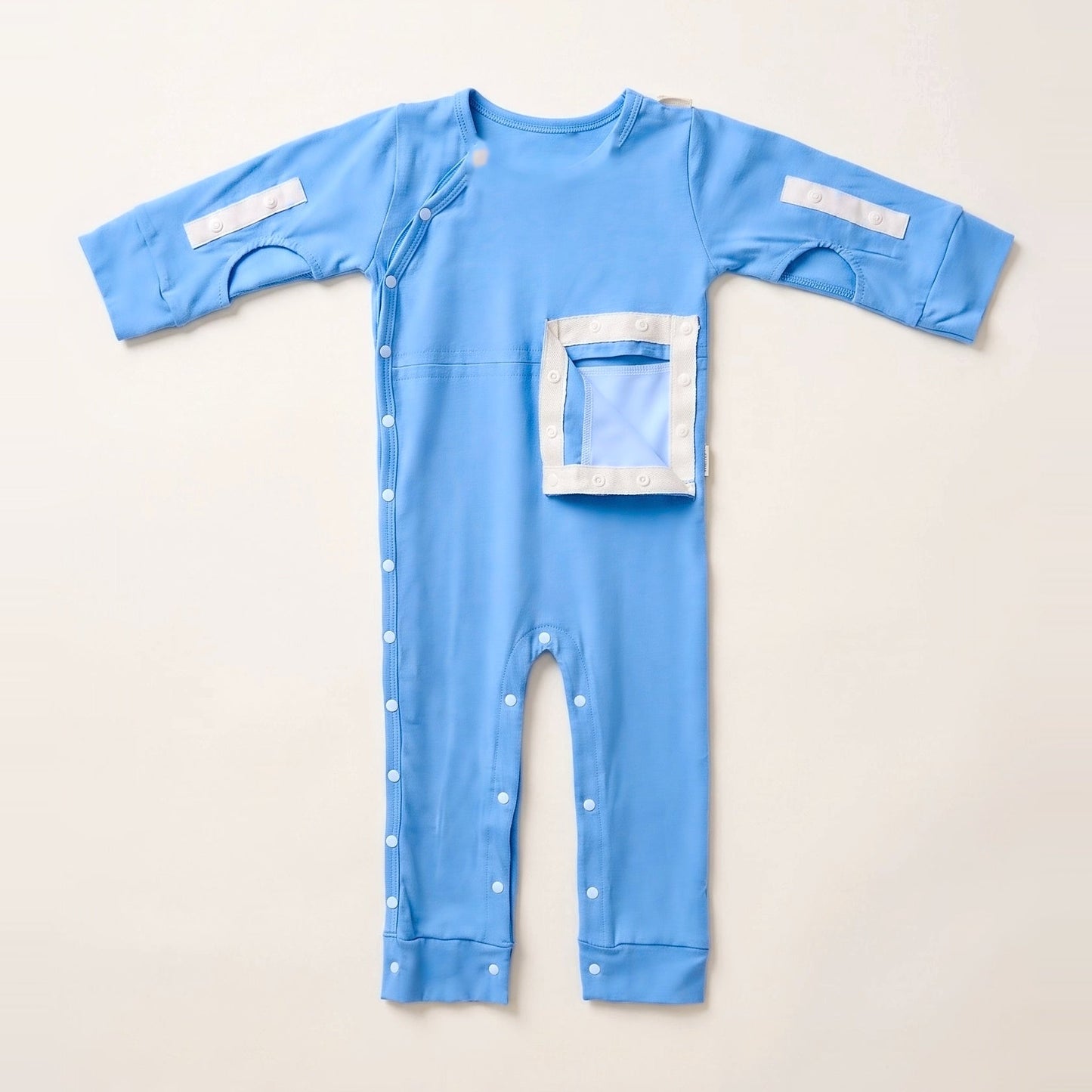 Sky Lullaby G/J tube bodysuit with the PediaPouch opened, showing the moisture-resistant interior lining