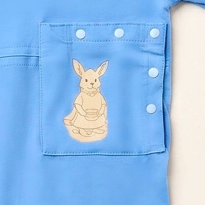 Close-up of the PediaPouch snap-close tube pocket with kangaroo detail on the Sky Lullaby bodysuit
