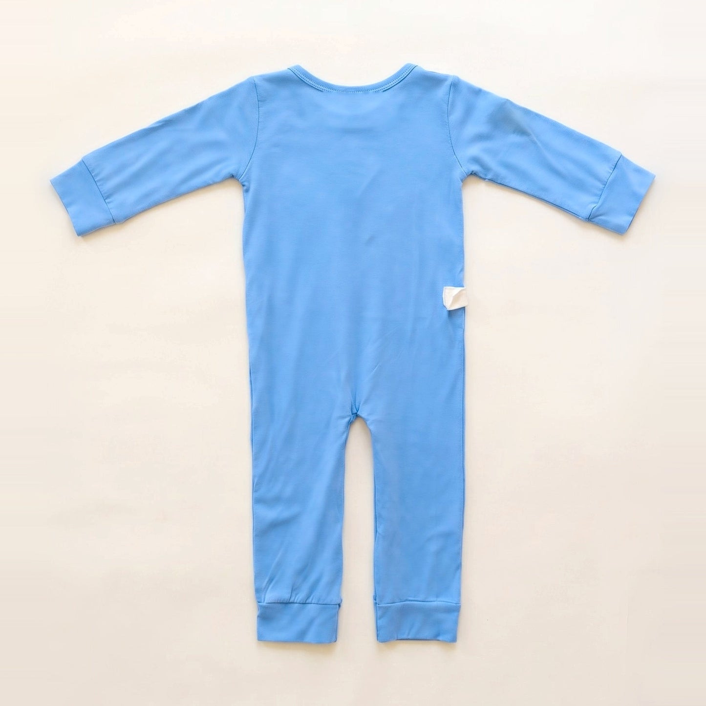 Back of the Sky Lullaby adaptive bodysuit showing shoulder and lower-back RoutePoints line guides