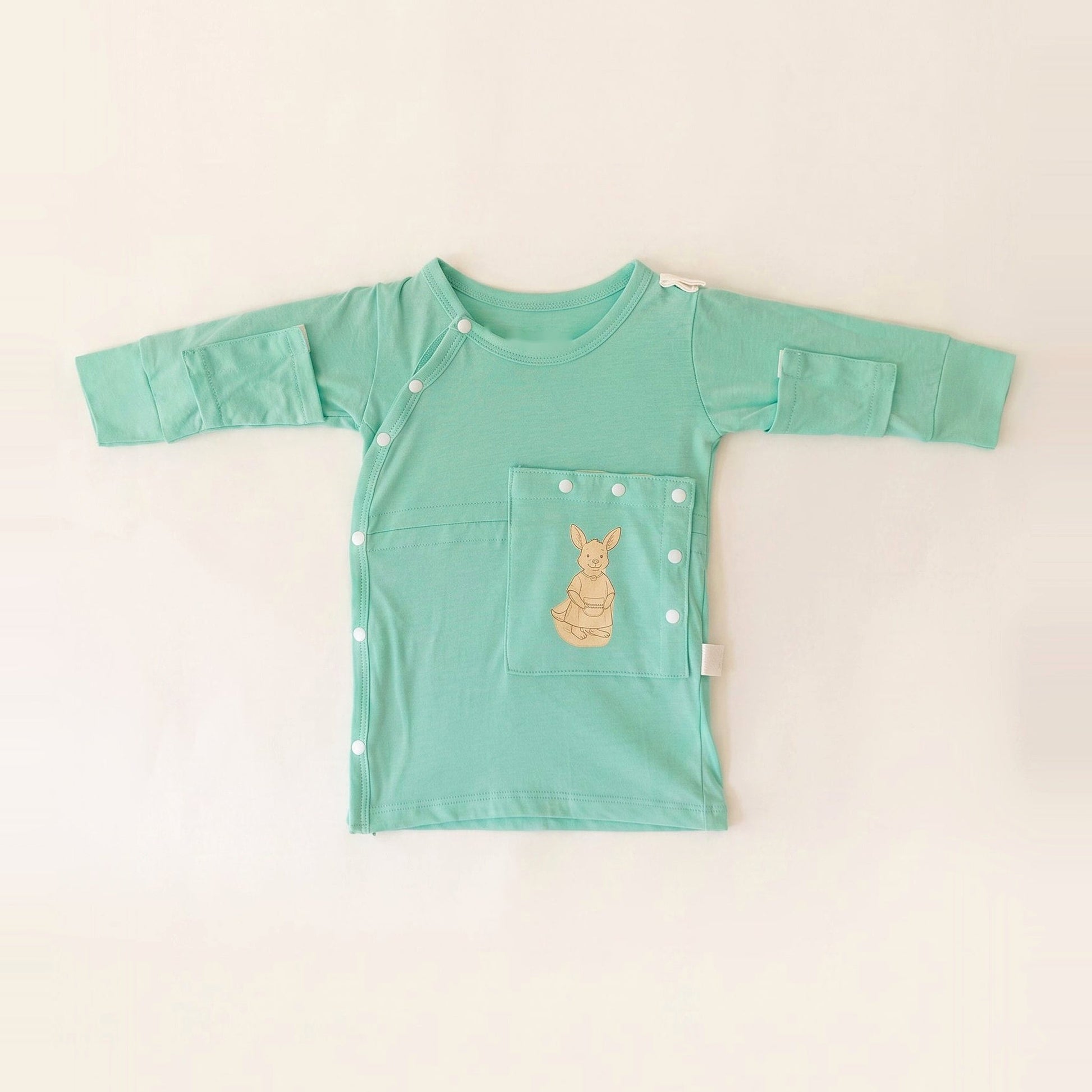 TubeWear adaptive G/J tube gown for newborns in Calm Mint, laid flat with the PediaPouch tube pocket closed