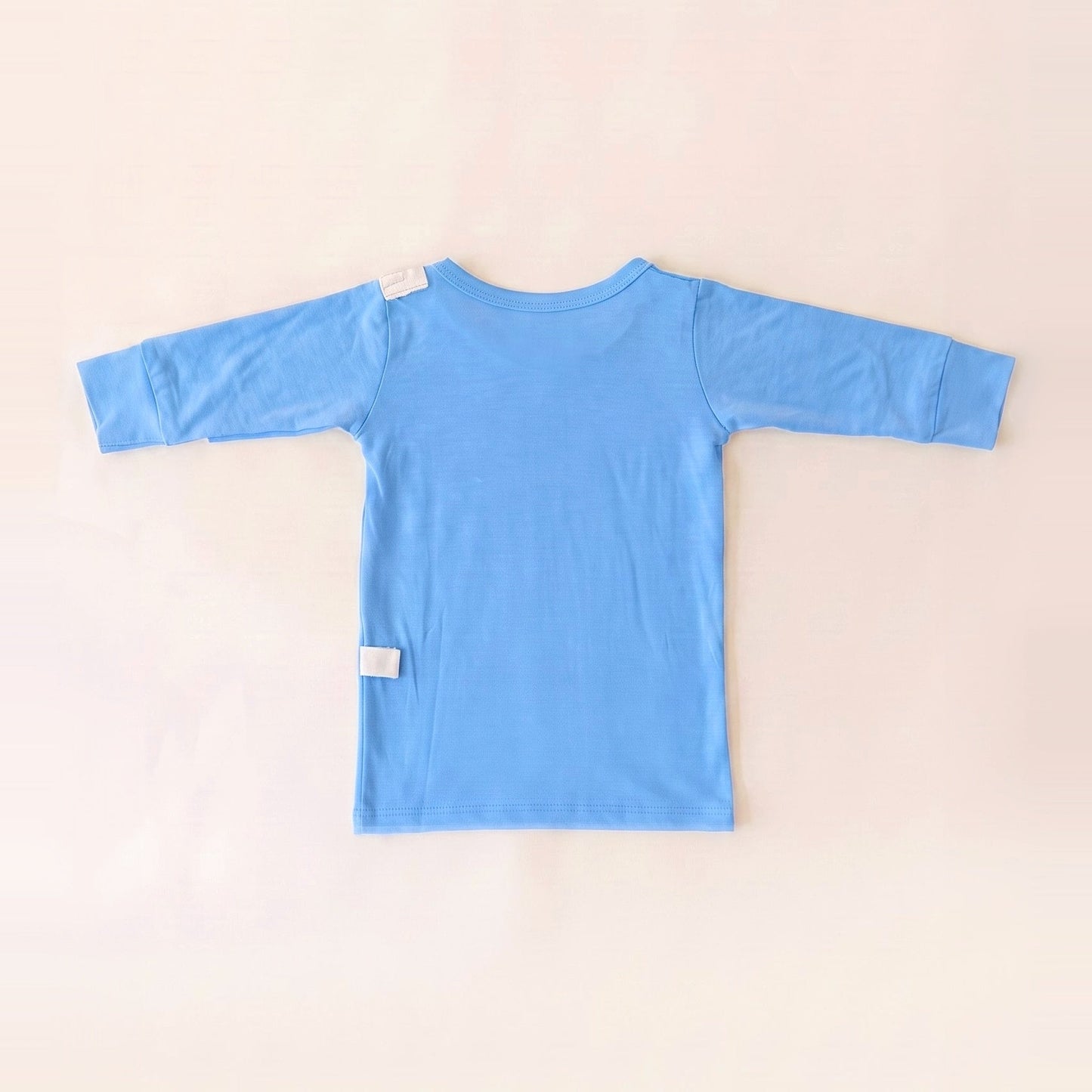 Back of the Sky Lullaby adaptive infant gown showing shoulder and lower-back RoutePoints line guides