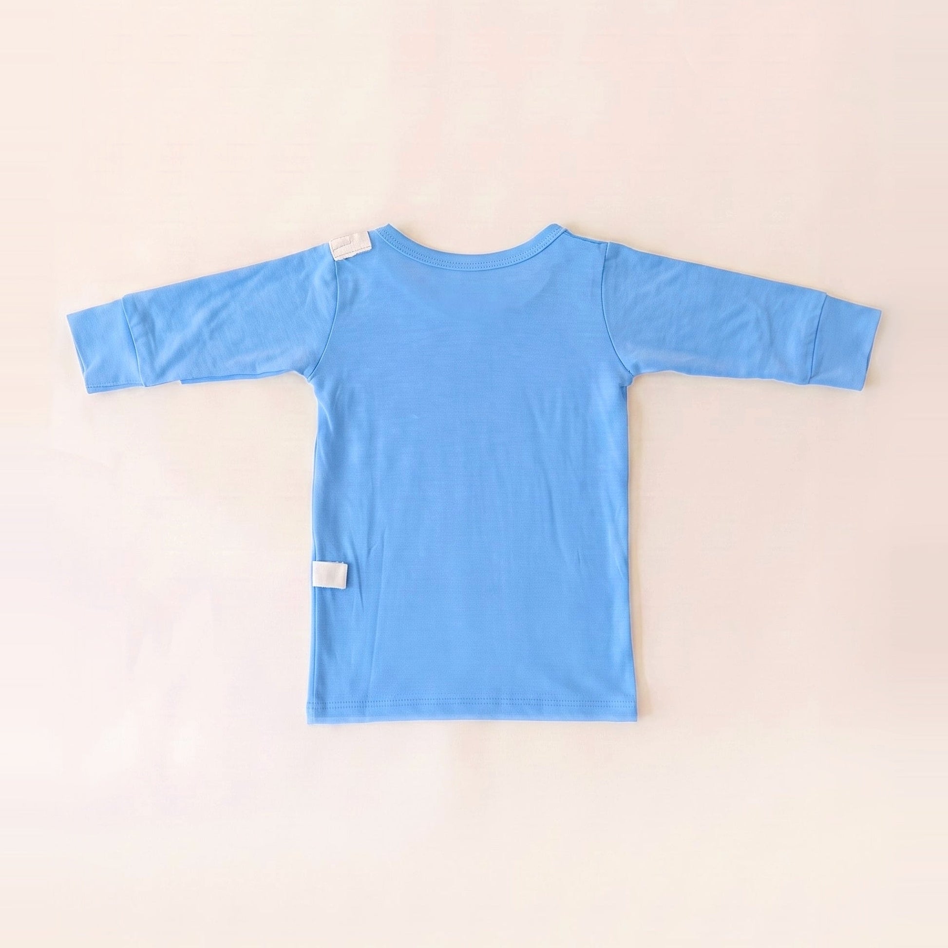 Back of the Sky Lullaby adaptive infant gown showing shoulder and lower-back RoutePoints line guides